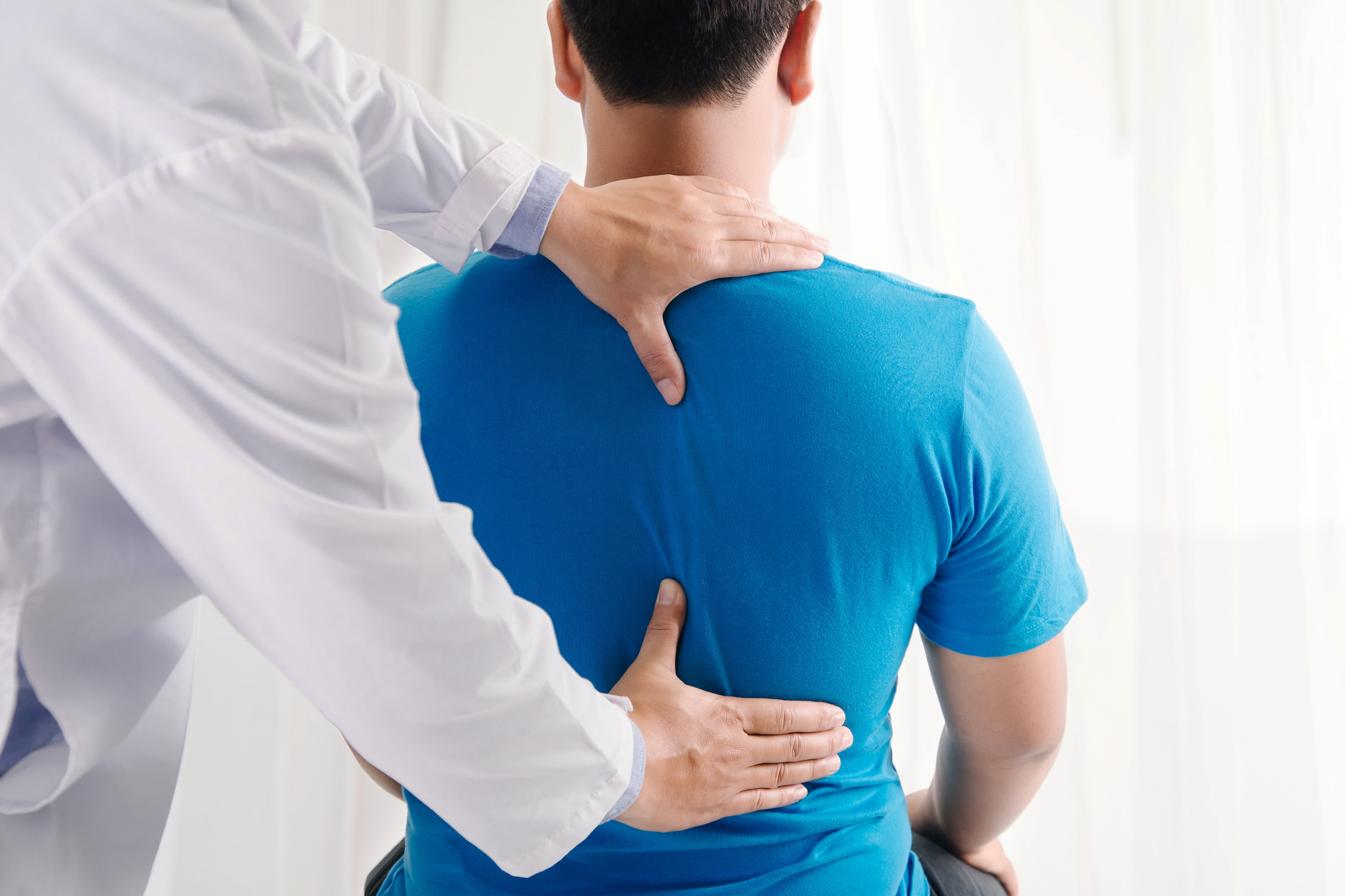 physiotherapist diagnosing back pain
