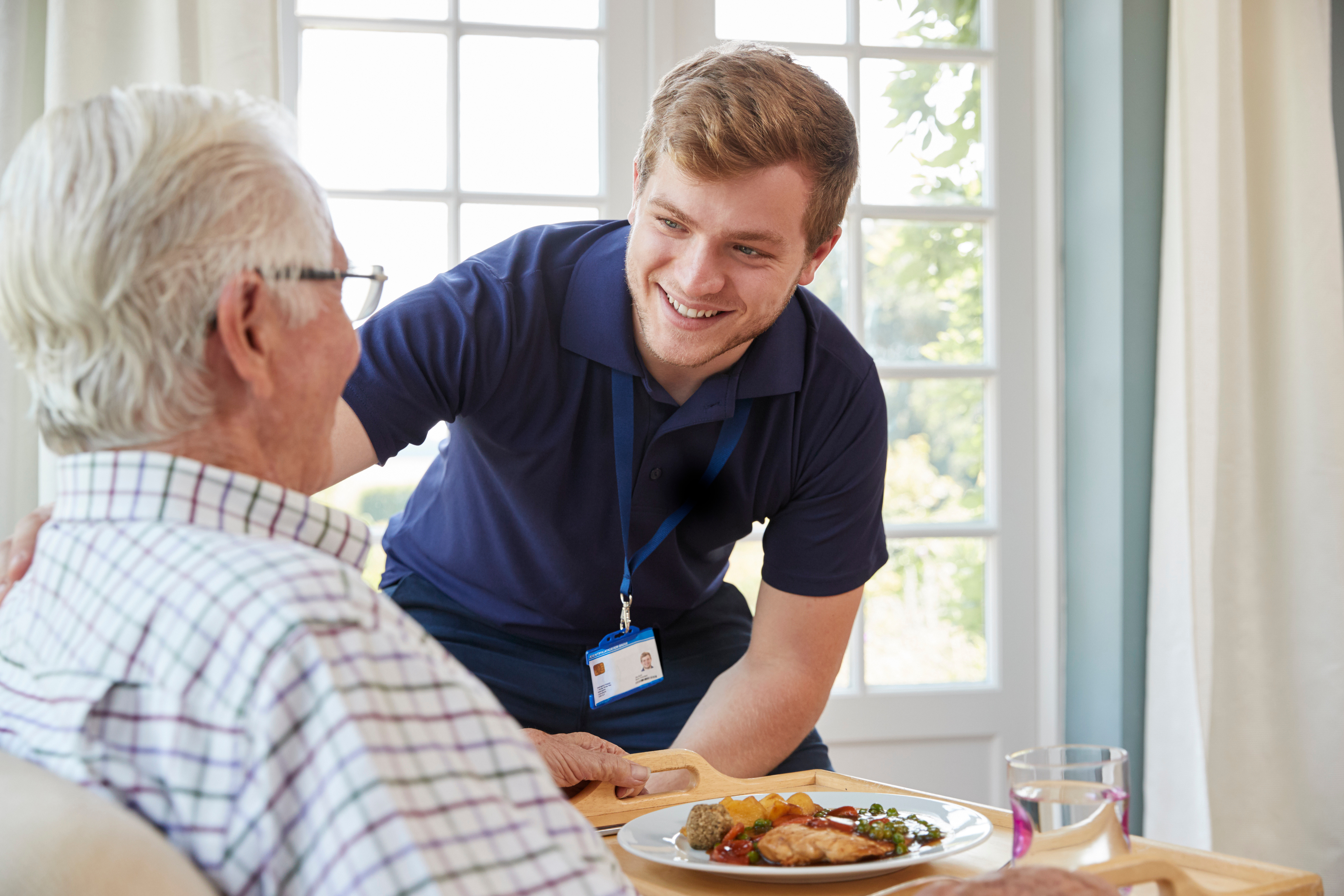 Physiotherapist helping old patient 